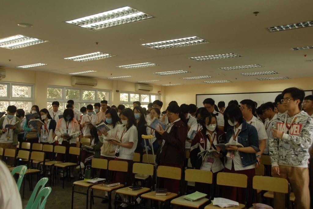 Students singing with their hymnals