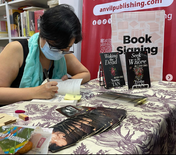 Yvette Tan signing books
