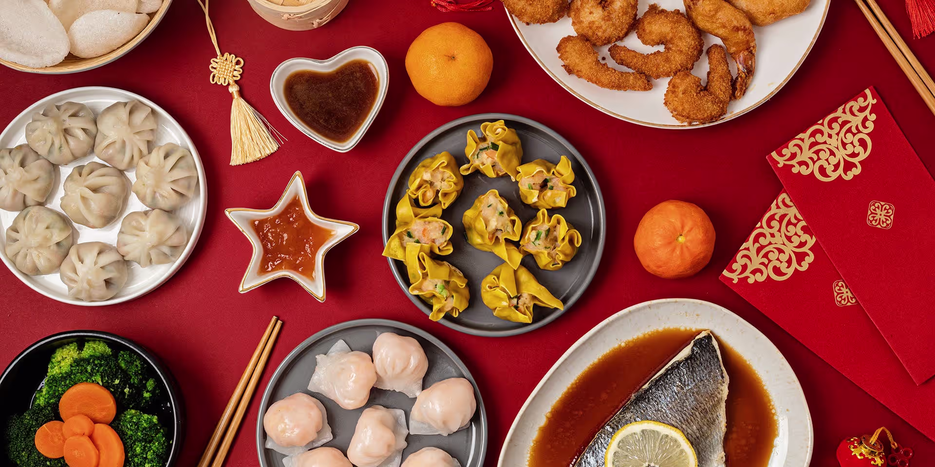 Table of Chinoy celebration food featuring hake, prawns, siomai, and xiaolongbao, served together as shared dishes symbolizing family gatherings and cultural tradition.